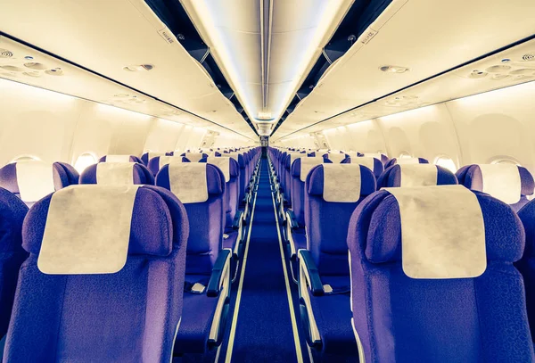 Empty passenger airplane seats in the cabin - retro vintage filt