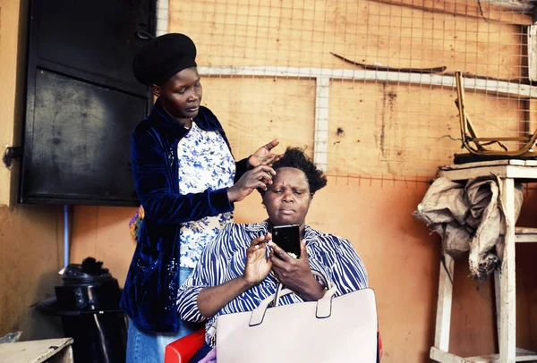 At the hairdresser in Jinja