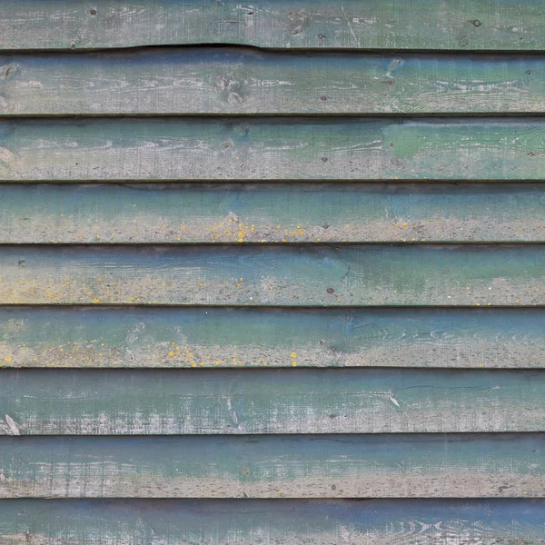 Square part of shed wall consisting of old wooden planks with fa — Stock Photo, Image