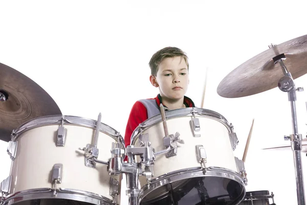 Nastolatek gra perkusji w studio z białym tłem — Zdjęcie stockowe
