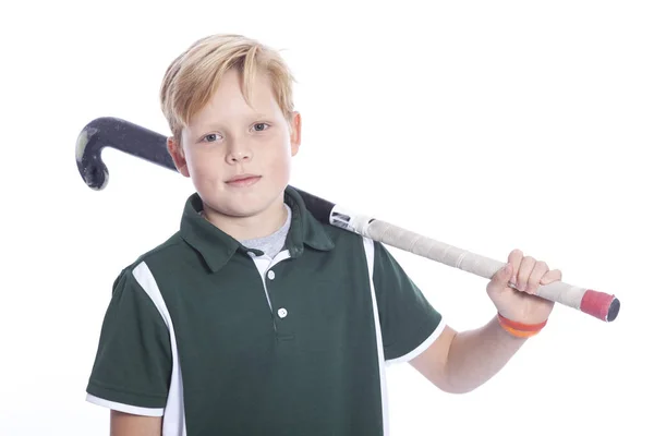 Blond boy with field hockey stick in studio — Stock Photo, Image