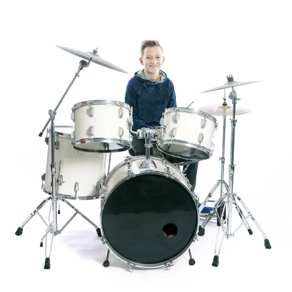 Teenage boy behind drum kit in studio — Stock Photo, Image