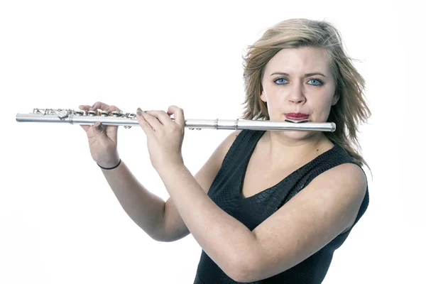 Young blond woman plays the flute against white background — Stock Photo, Image