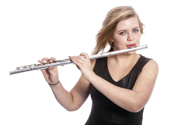 Young blond woman plays the flute against white background — Stock Photo, Image