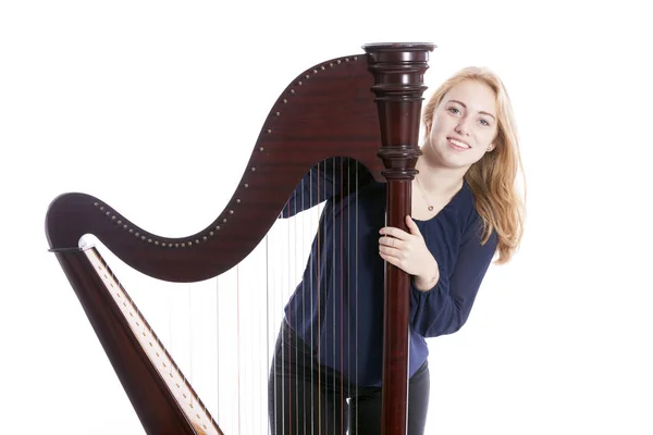 Red blond teenage girl and her harp against white studio backgro — Stock Photo, Image
