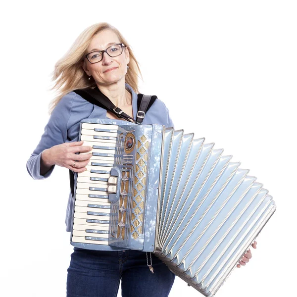 Woman in blue with glasses plays accordeon and smiles — Stock Photo, Image