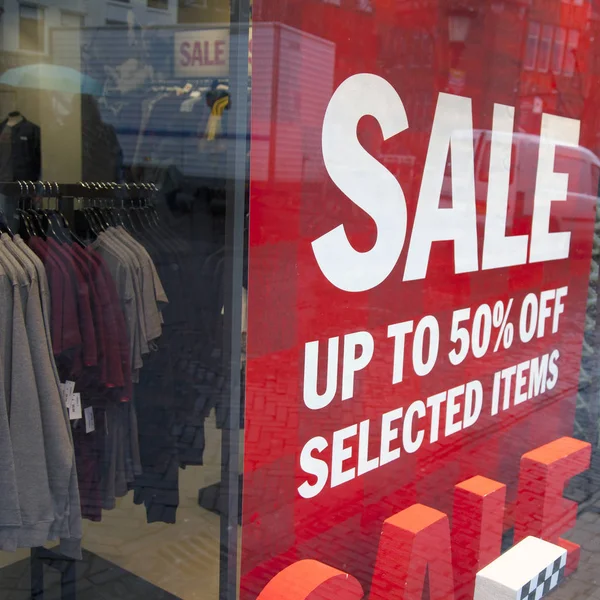 Sale signs in display window of clothing store — Stock Photo, Image