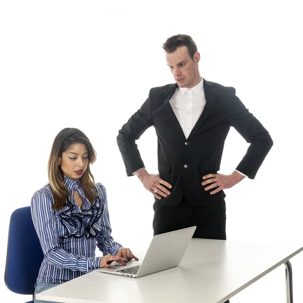 secretary works with laptop at table and boss seems not amused