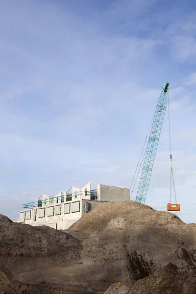 Grey concrete of new housing in the netherlands with crane — Stock Photo, Image