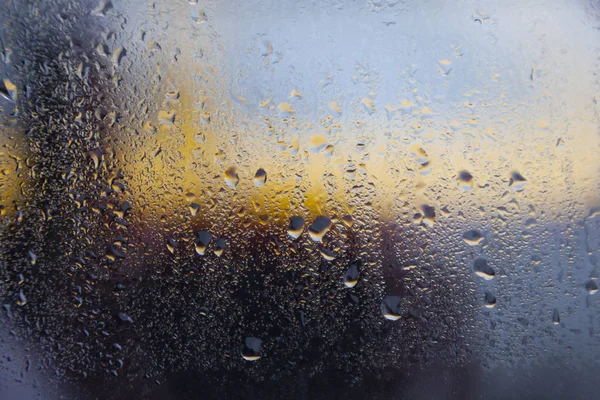 Raindrops on window of car and yellow background — Stock Photo, Image