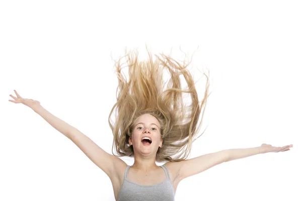 Young teen girl with blond wavy hair up in the air — Stock Photo, Image