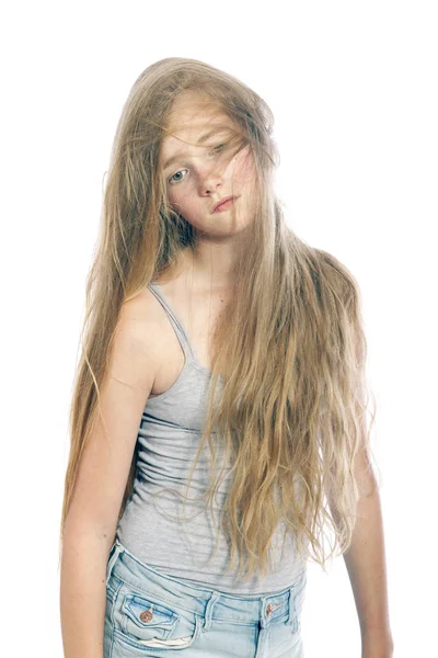 Young sad teen girl hides behind blond wavy hair against white b — Stock Photo, Image