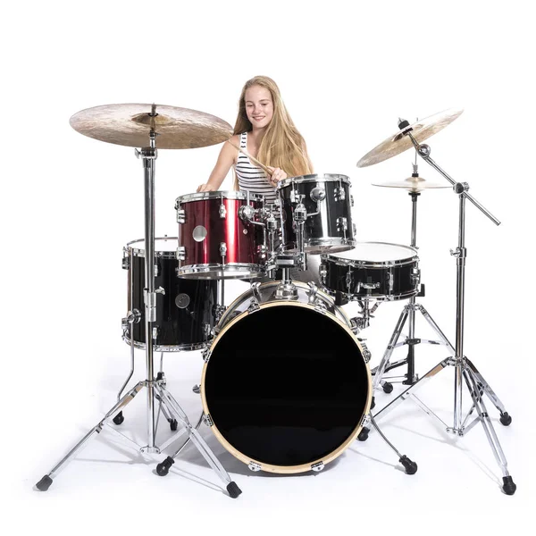 Młoda blond nastolatek dziewczyna gra na perkusji w studio przeciwko biały — Zdjęcie stockowe