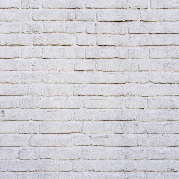 square part of white painted brick wall