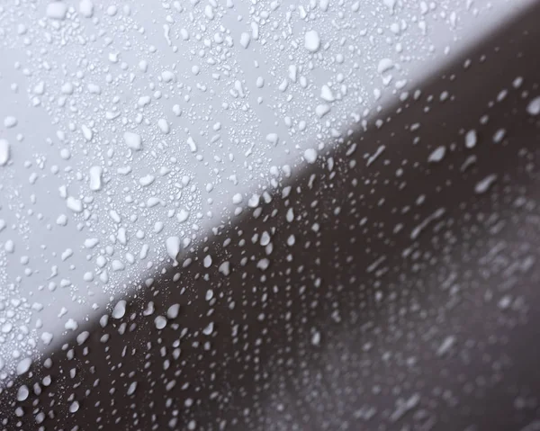 Water droplets on white surface of car body — Stock Photo, Image