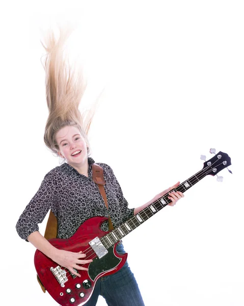 Blond teen girl with electric bass guitar against white background — Stock Photo, Image