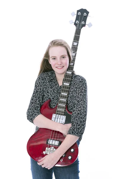 Blond teen dziewczyna i gitara basowa na białym tle w studio — Zdjęcie stockowe