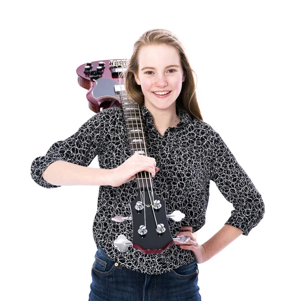 Blond teen girl and bass guitar against white background in studio — Stock Photo, Image