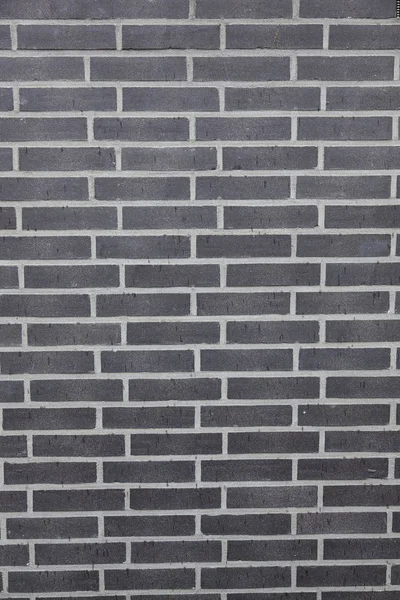 Achtergrond bestaande uit deel van antraciet bakstenen muur — Stockfoto