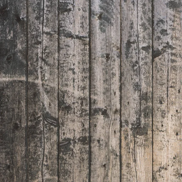 Background consisting of old brown gray grungy part of wooden barn door — Stock Photo, Image