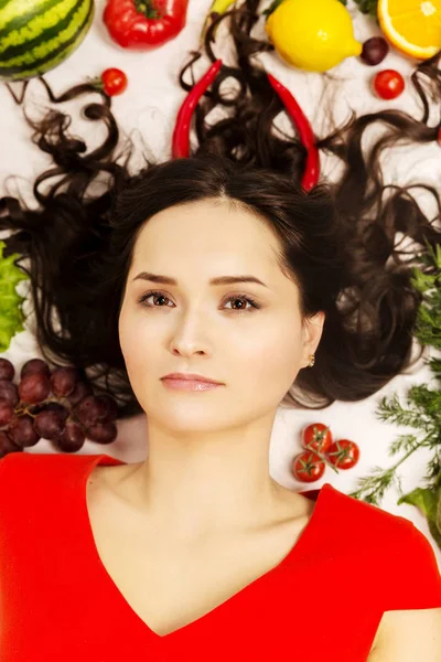 Beautiful young woman, lots of fruits and vegetables — Stock Photo, Image