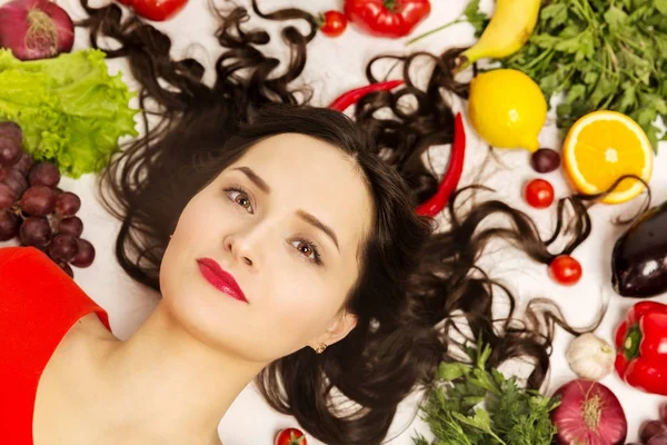 Beautiful young woman, lots of fruits and vegetables — Stock Photo, Image