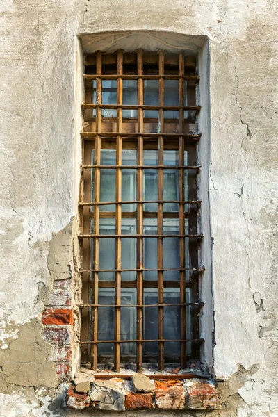 Gated window on the wall of an old building