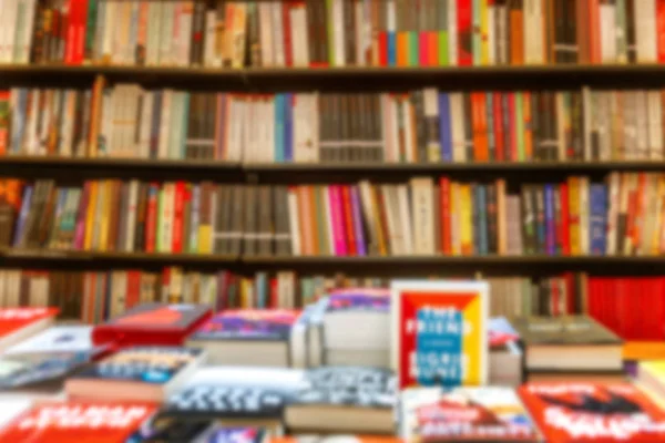 A large assortment of books on shelves in a bookstore. Blurred. Background. Space for text. — Stock Photo, Image