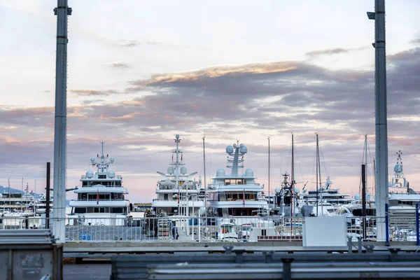 Velké bohaté jachty v přístavu Monte Carlo při západu slunce. Krásný výhled. — Stock fotografie