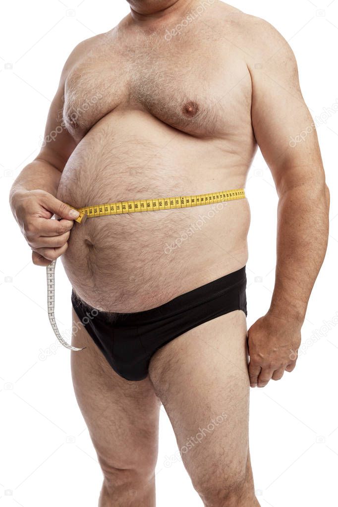 A fat man in shorts measures the volume of the abdomen. Isolated over white background. Close-up. 