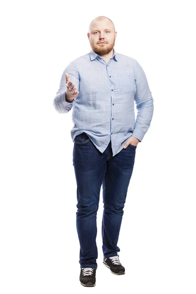 Smiling red-haired young man with a beard in a blue shirt and full-length jeans. Isolated over white background. — 스톡 사진