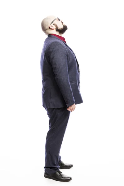 A bald man in a suit looks up. Side view. Full height. Isolated on a white background. — 스톡 사진