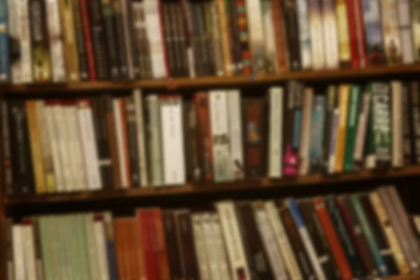A large number of books on shelves in the closet. Close-up. Blurred. — Stock Photo, Image