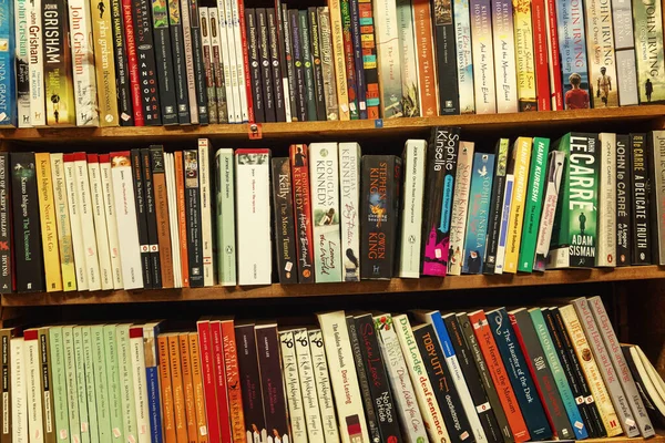 Marseille, France, 10/07/2019: Rows of old books on shelves in a store. Close-up. — Stock Photo, Image