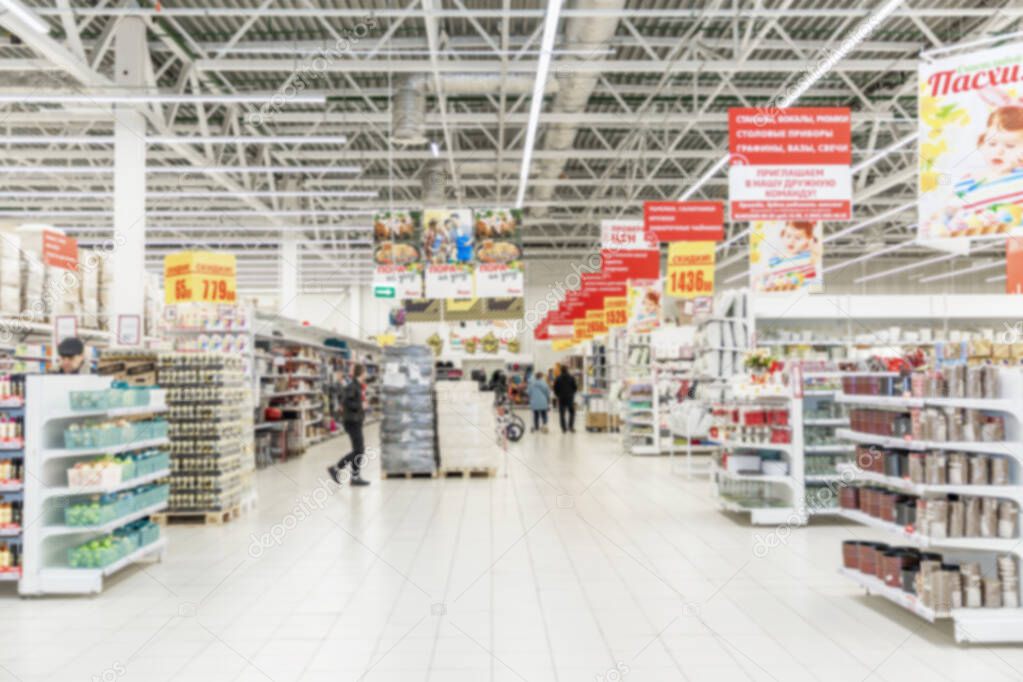 The interior of a large hypermarket. Blurred.