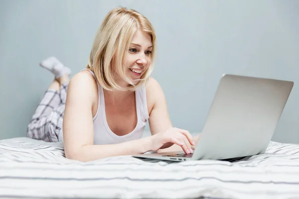 Smiling Woman Lies Bed Communicates Internet Laptop Remote Work Coronavirus — Stock Photo, Image