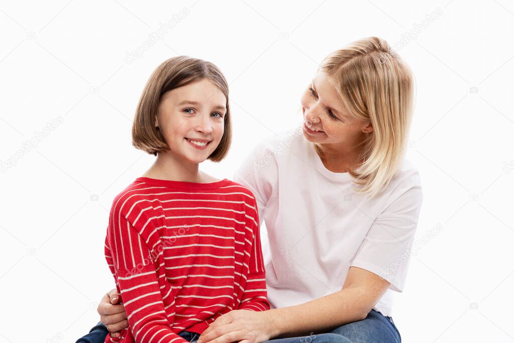 Daughter teenager and mother laugh and hug. Love and support in family relationships. White background. Space for text.