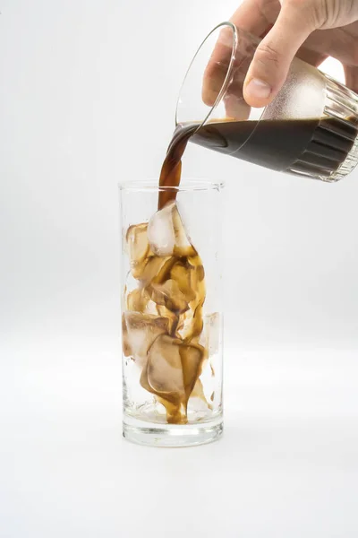 Pouring espresso coffee into a glass of ice — Stock Photo, Image