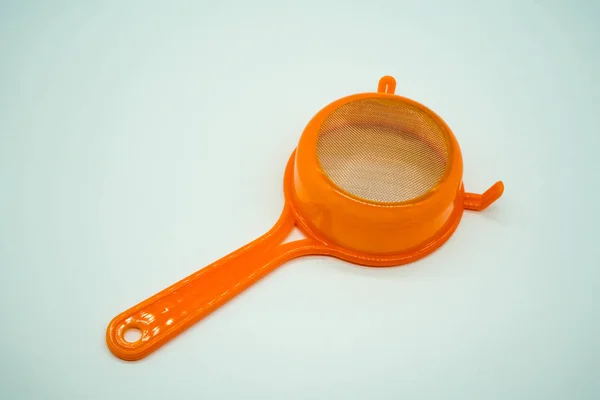 Mini kitchen sieve with orange plastic handle — Stock Photo, Image