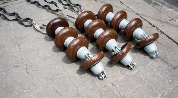 High voltage electricity cable connected with brown ceramic insulator