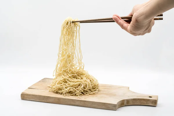 木製 chopp で箸で生卵麺を持っている手 — ストック写真
