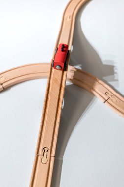 Plastik ahşap parça üzerinde beyaz izole kırmızı tren oyuncak 