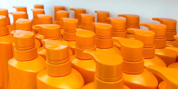 Round orange plastic bottle with dispenser pump for liquid soap, — Stock Photo, Image