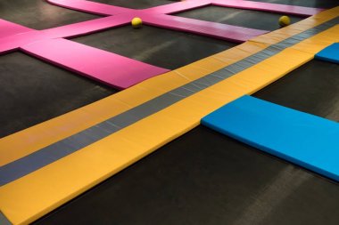 Interconnected trampolines for indoor jumping clipart