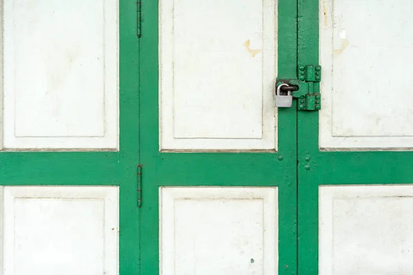 Closed up on vintage white and green wood door with silver lock. — Stock Photo, Image