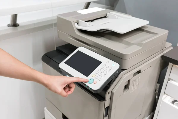 Woman's hands pressing button on copy machine — Stock Photo, Image