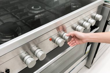 Kadının el fırın Makinası ısı düğmesini ayarlama