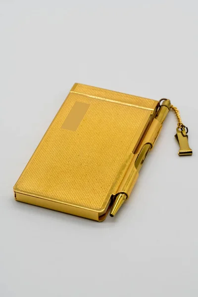 Gold personal vintage notebook case with pen isolated on white — Stock Photo, Image