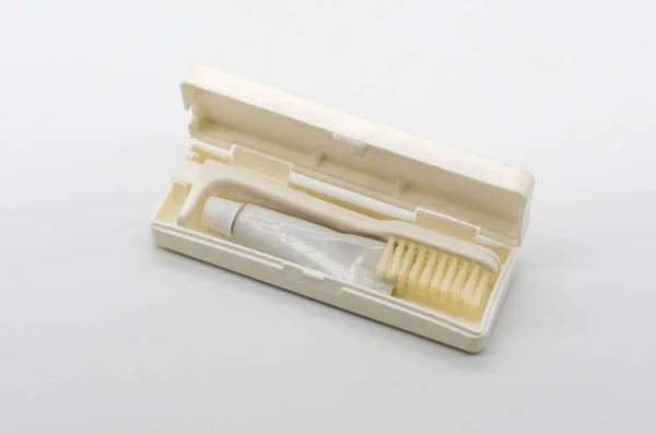 Ταξίδια πτυσσόμενα οδοντόβουρτσα με οδοντόπαστα που απομονώνονται σε λευκό — Φωτογραφία Αρχείου