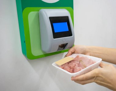 Customer hand scanning barcode of food under price scanner machi clipart
